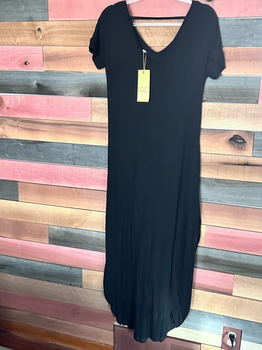 Grecerelle black maxi dress features a V-neckline, short sleeves, tie front